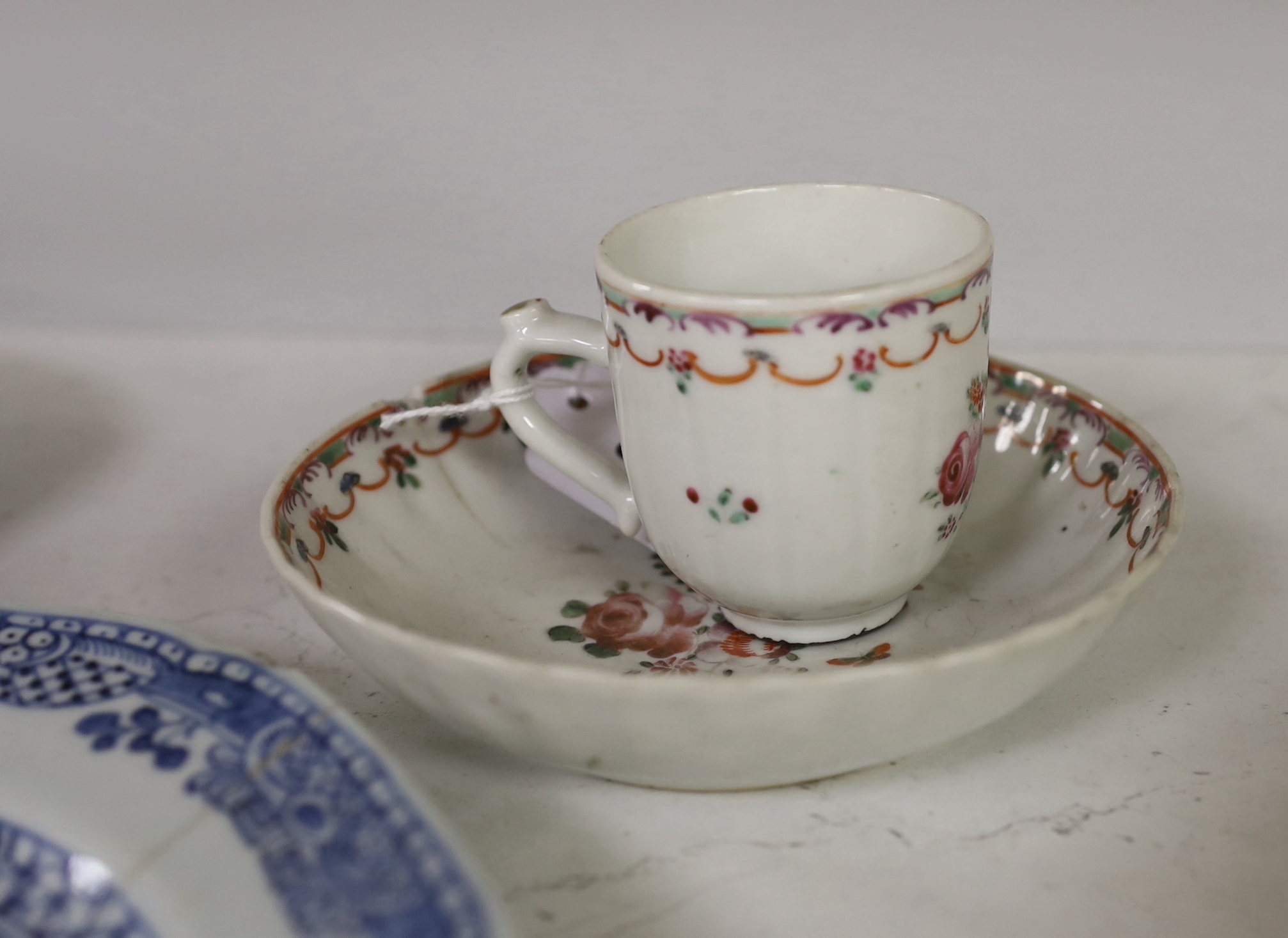 An 18th century Chinese export famille rose teacup and saucer, a similar blue and white octagonal dish, two teabowls and saucers and a plate, largest 23cm